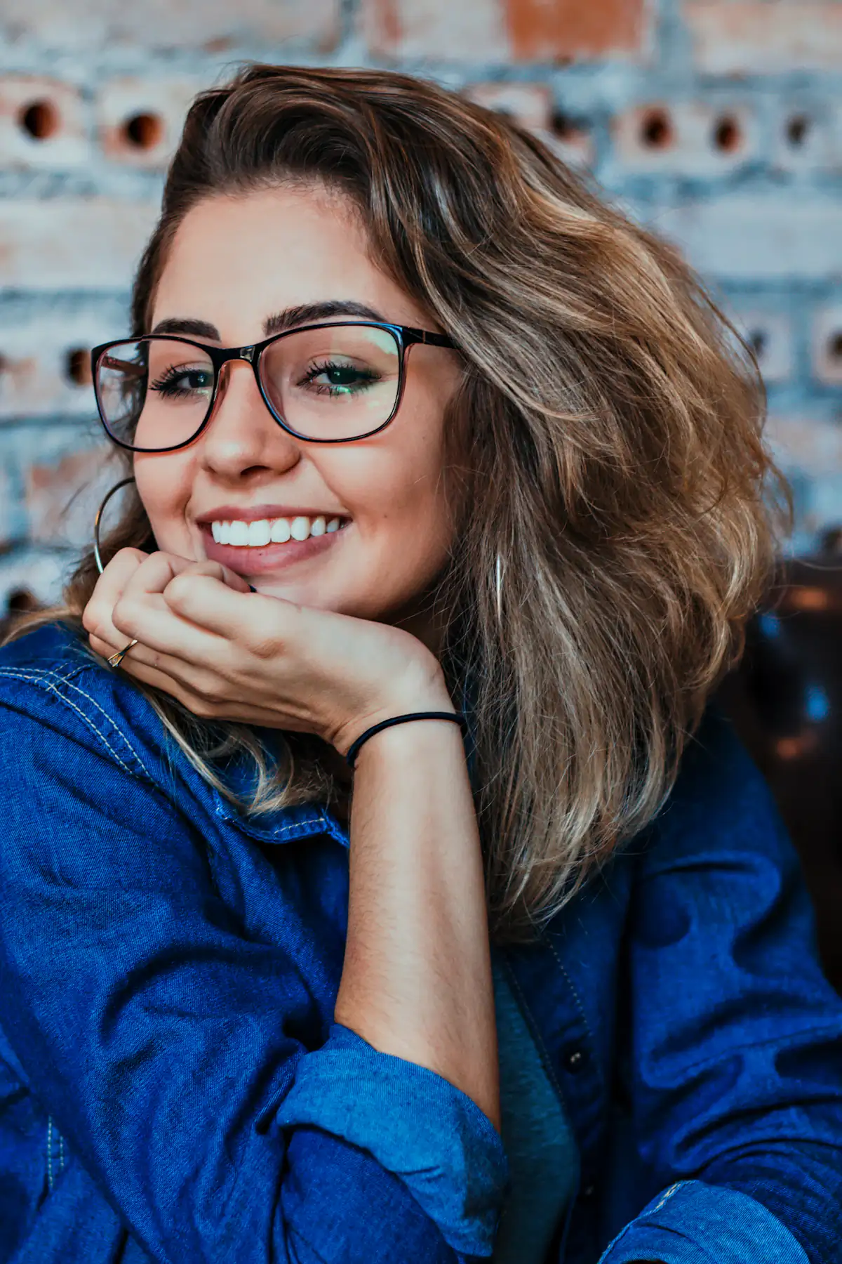 Smiling woman wearing black-framed glasses